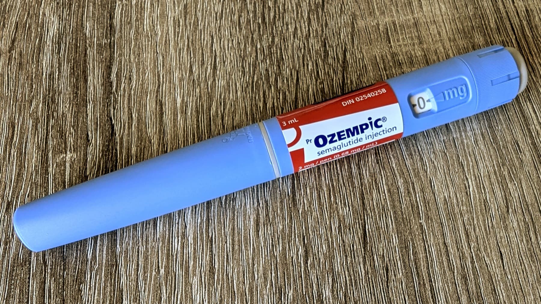 Semaglutide injection pen photographed on a tabletop, used for GLP-1 maintenance coverage.